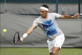  ?? PETER KLAUNZER — KEYSTONE VIA AP ?? Roger Federer practices for Wimbledon on July 1 in London.