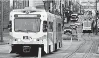  ?? JERRY JACKSON/BALTIMORE SUN ?? A north bound MTA light rail train travels up Howard Street at Mulberry in downtown Baltimore.