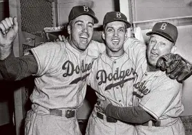  ?? Anonymous/Associated Press ?? Carl Erskine, center, said Branch Rickey steered Larry Doby to Cleveland to break the American League’s color barrier.