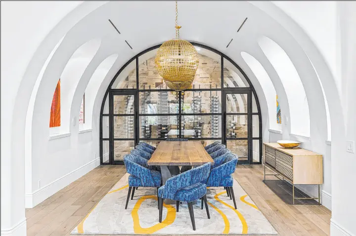 ?? Ivan Sher Group ?? Cookbook author Julie Hession remodeled her Summerlin home to feature an arched formal dining room with wine cellar. The home was recently listed for $3.95 million.