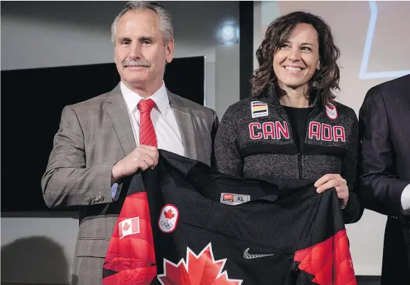  ?? — THE CANADIAN PRESS FILES ?? Willie Desjardins, the Canadian men’s Olympic hockey team coach (shown here with Team Canada chef de mission Isabelle Charest) will see both of his big passions — hockey and Canada — intersect next month at the Winter Games in South Korea.