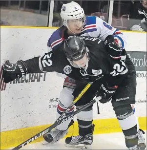  ?? JASON SIMMONDS/TC MEDIA ?? Summerside D. Alex MacDonald Ford Western Capitals defenceman Alex McQuaid and the Dieppe Commandos’ Will Lafford battle for positionin­g during Tuesday night’s MHL (Maritime Junior Hockey League) playoff game at Eastlink Arena. The Commandos won the...