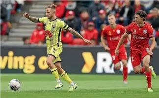  ?? GETTY IMAGES ?? Wellington Phoenix striker David Ball gets in behind Adelaide’s defence during their A-League match on Sunday.