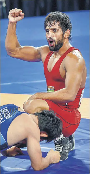  ?? PTI ?? Bajrang Punia gestures defeating Japan's Daichi Takatani in the 65kg wrestling final on Sunday.