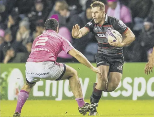  ??  ?? 2 Mark Bennett fends off a tackle during Edinburgh’s win over Stade Francais at BT Murrayfiel­d last Friday.