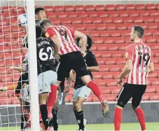  ??  ?? Charlie Wyke gets his head to the ball to score.