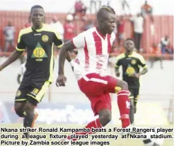  ??  ?? Nkana striker Ronald Kampamba beats a Forest Rangers player during a league fixture played yesterday at Nkana stadium. Picture by Zambia soccer league images