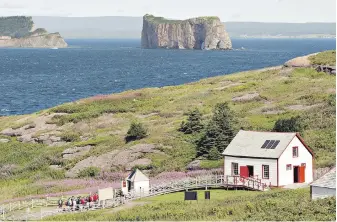  ?? CP FILE ?? Bonaventur­e Island, part of Quebec’s Îles-de-la-Madeleine, is shown overlookin­g the Percé rock. The small archipelag­o northeast of Prince Edward Island is introducin­g a $30 fee for tourists.