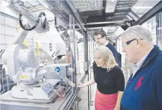  ?? Picture: Nev Madsen ?? FUTURE BUSINESS: Inspecting the new robotic manufactur­ing equipment at Wagners’ CFT business are State Developmen­t Minister Kate Jones, (back) Wagners CFT general manager Michael Kemp and (front) non-executive director John Wagner.