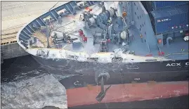  ?? [ITOSHI TAKANO/KYODO NEWS] ?? The container ship ACX Crystal, with its left bow dented and scraped from its collision with the USS Fitzgerald, weighs nearly four times what the destroyer does.