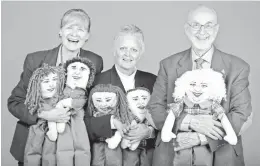  ??  ?? Janete Palovich, Louise Palovich and George Palovich hold dolls representi­ng family members.