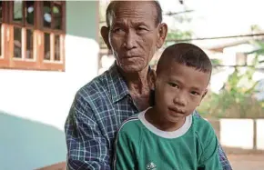  ??  ?? Five- year- old Kittipop’s grandmothe­r Chapen ( left pic) and grandfathe­r Prajak ( right pic) dote on him but it’s still difficult to grow up with absent parents whom he only sees once a year.