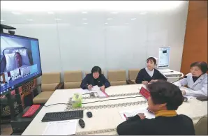  ?? ZOU HONG / CHINA DAILY ?? Doctors from Beijing Union Clinic Partner participat­e in a video call consultati­on in February.