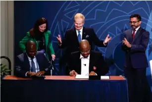  ?? (Getty) ?? Nasa administra­tor Bi ll Ne l son (centre) ce l ebrates as Rwanda’s Co l one l Francis Ngabo ( l eft) and Nigeria’s Isa A li I brahim (right) sign on to the Artemis Accords in December