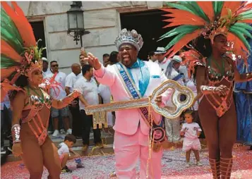  ?? BRUNA PRADO/AP ?? Key figure: Carnival King Momo, Djferson Mendes da Silva, holds the key to the city Friday at the official start of Carnival in Rio de Janeiro. Some 46 million people across Brazil are expected to join the festivitie­s, which continue into next week.