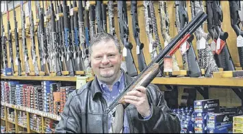  ?? ELAINE S. POVICH / PEW CHARITABLE TRUSTS ?? Mike Coombs, the owner of an outdoor store in Seattle, opposes the city’s gun tax. But city leaders say it will fund medical research on reducing gun violence. Gun rights groups are challengin­g the tax in court.