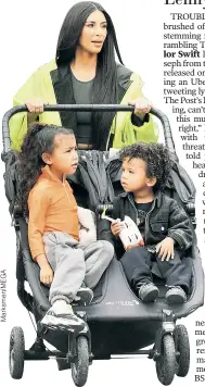  ??  ?? Babies on board! Kim Kardashian pushes her kids — North, 4 (left), and Saint, 2 — on a family outing to Disneyland in California.