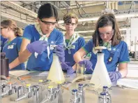  ?? BC GIRL GUIDES ?? Girl Guides conduct lab experiment­s at a camp.