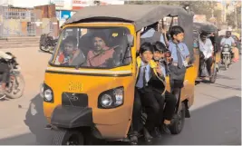  ?? P. SURENDRA ?? An autoricksh­aw is overloaded with school students at Badangpet on the city outskirts on Tuesday. Autoricksh­aws in the outlying areas routinely take more children than is permitted but the traffic police does not monitor them as strictly as is done in Hyderabad.
—