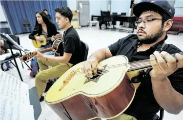  ?? Photos by Melissa Phillip / Staff photograph­er ?? Alexis Gonzalez plays the guitarrón during the Mariachi Pumas’ rehearsal at the University of Houston.