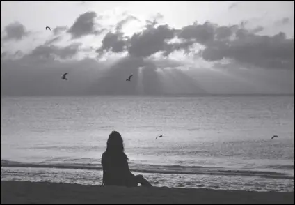  ?? ASSOCIATED PRESS FILES ?? A woman meditates on the beach in Miami Beach, Fla. According to a study published, Wednesday, in the journal JAMA Psychiatry, mindfulnes­s meditation worked as well as a standard drug for treating anxiety in the first head-to-head comparison.