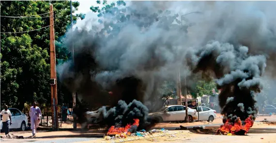  ?? AFP ?? Tires are pictured ablaze as Sudanese protesters rally on Wednesday in Khartoum and its twin city, Omdurman, as well as in other cities across the country against a worsening economic crisis.