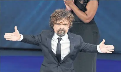  ?? KEVIN WINTER GETTY IMAGES ?? Peter Dinklage wins best supporting actor in a drama for Game of Thrones, which also won the Emmy for best drama series.