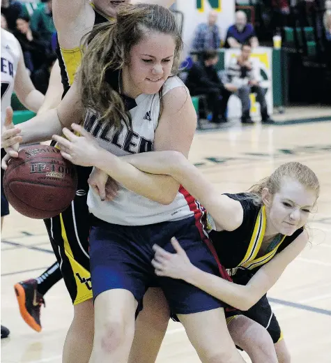  ?? BRYAN SCHLOSSER/Leader-Post ?? Miller’s Katie Bastedo keeps the ball from Luther’s Alexis Pflanzner during the small schools high school basketball final between the Miller Maraudersa­nd Luther Lions at Campbell Collegiate on Wednesday. Miller defeated Luther 75-53.