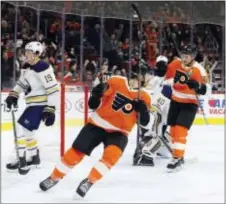  ?? CHRIS SZAGOLA — THE ASSOCIATED PRESS ?? Flyers left wing Michael Raffl pumps a gloved fist in reaction to the goal scored by center Valtteri Filppula, right, which Raffl assisted on Thursday night against the Sabres at Wells Fargo Center.