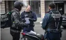  ??  ?? Officers check a motorcycli­st’s travel certificat­e. Photograph: Christophe PetitTesso­n/EPA