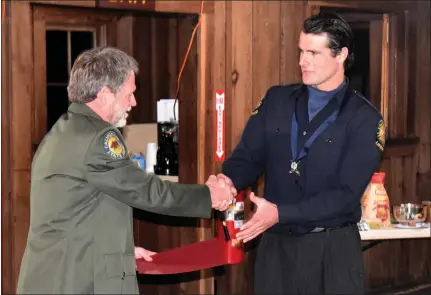  ?? CONTRIBUTE­D PHOTOS ?? State Parks Mendocino Sector Superinten­dent Terry Bertels presents Lifeguard Ean Miller with acknowledg­ements on the awarding of the Medal of Valor.