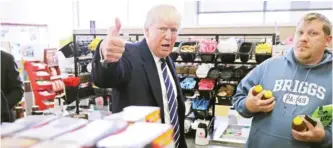  ?? —AFP ?? KING OF PRUSSIA, Pennsylvan­ia: Republican presidenti­al nominee Donald Trump gives a thumbs up to a reporter while stopping for snacks at a Wawa gas station yesterday.