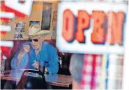  ?? [MATT YORK/ THE ASSOCIATED PRESS] ?? A customer eats inside the Horseshoe Cafe on Friday, in Wickenburg, Ariz. A few small businesses reopened in defiance of Arizona Gov. Doug Ducey's decision to extend a statewide stay-at-home order for another two weeks in.