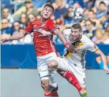  ?? Gus Ruelas Associated Press ?? WITH THE BALL in the air, the Galaxy’s Daniel Steres, right, and Dallas’ Cristian Colman have a header in mind.