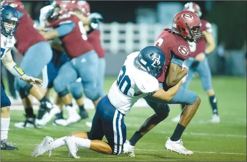  ?? (Special to NWA Democrat-Gazette/David Beach) ?? Springdale Har-Ber’s Efrin Chavez (center) makes the hit on Springdale’s Kaylon Morrison Friday at Jarrell Williams Bulldog Stadium in Springdale.