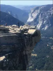  ?? AP PHOTO VIA JOHN P. DEGRAZIO ?? A cloud of dust is seen in the distance on El Capitan Wednesday after a major rock fall in Yosemite National Park. All areas in California’s Yosemite Valley are open Thursday, a day after the fatal rock fall.