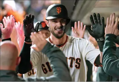  ?? Thearon W. Henderson
/ Getty Images /TNS ?? Kris Bryant (23) of the San Francisco Giants is congratula­ted by teammates after hitting a two-run home run against the Newyork Mets in the bottom of the fifth inning at Oracle Park on Monday in San Francisco.