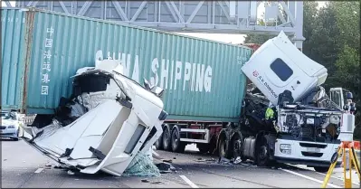  ??  ?? Wreckage: The crashed lorries on the A14 yesterday. This shot was taken by a press photograph­er