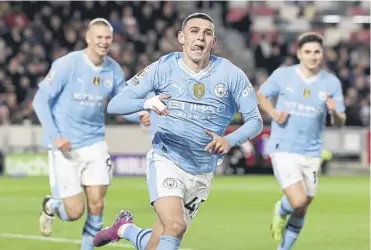  ?? ?? Phil Foden heads off to celebrate with the City supporters after scoring the second of his three goals