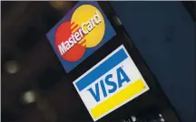  ?? MATT ROURKE — THE ASSOCIATED PRESS ?? The ability for some Americans to keep buying things with plastic and then pay the bill likely depends on whether current negotiatio­ns in Washington produce another round of economic aid.