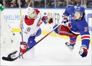  ?? The Associated Press ?? New York Rangers’ Mats Zuccarello and Montreal Canadiens’ Brandon Davidson collide during the second period of an NHL hockey game in Game 4 of an NHL game Tuesday in New York.