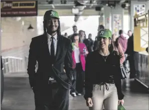  ?? Hanh Truong HECTOR AMEZCUA/SACRAMENTO BEE ?? DaSean Spencer and Sierra Zavala of the Greater Sacramento Economic Council wear Oakland Athletics caps as they walk in the concourse at Sutter Health Park on Thursday.