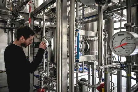  ?? ?? An employee of “Bordeaux Families”, one of the largest wine cooperativ­es, in the Bordeaux region, checks a wine dealcoholi­sation unit, in Sauveterre-de-Guyenne, south-western France.