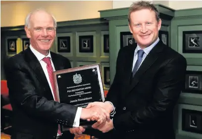  ??  ?? Jamie Donaldson receiving the PGA Recognitio­n Award with PGA chief executive Sandy Jones