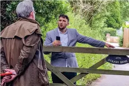  ??  ?? Confrontat­ion: Patrick Doran, right, blocks Mail reporter Robert Hardman’s way in the village earlier this summer