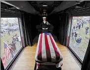  ?? AP/DAVID J. PHILLIP ?? An honor guard member watches over the casket of former President George H.W. Bush as the funeral train passes through Magnolia, Texas, on Thursday.