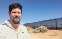  ?? ANGELA KOCHERGA/JOURNAL ?? Myles Traphagen, borderland­s program coordinato­r with the Wildlands Network, recently toured the area where constructi­on workers are putting up an 18-foot steel barrier in Santa Teresa.