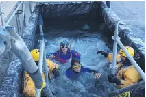  ??  ?? Polar Plunge participan­ts chill out in icy dumpster at Algonquin College.