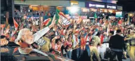  ?? ?? PM Modi waves to the people during a roadshow in Valsad on Saturday.