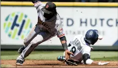  ?? BETTINA HANSEN/TRIBUNE NEWS SERVICE ?? The Mariners' Dee Gordon steals second, sliding into Giants second baseman Alen Hanson's glove at Safeco Field in Seattle on Wednesday.